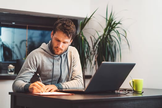Person working on a laptop with AI content on screen, home office