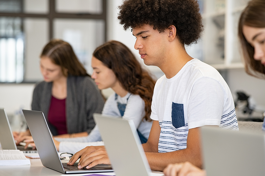 falsely accused of using AI - student laptop classroom studying photo