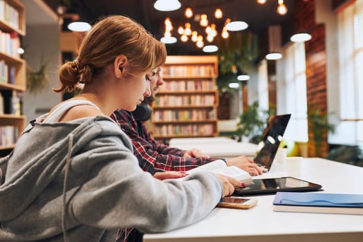 falsely accused of using AI - university library students studying photo