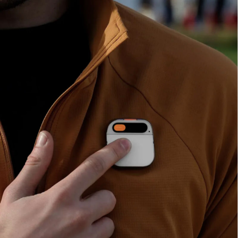 Portable AI assistant gadget held in hand for travel use