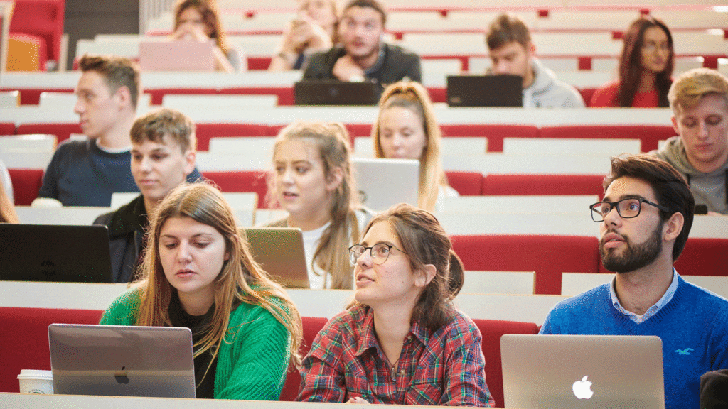 University students using laptops in a lecture hall