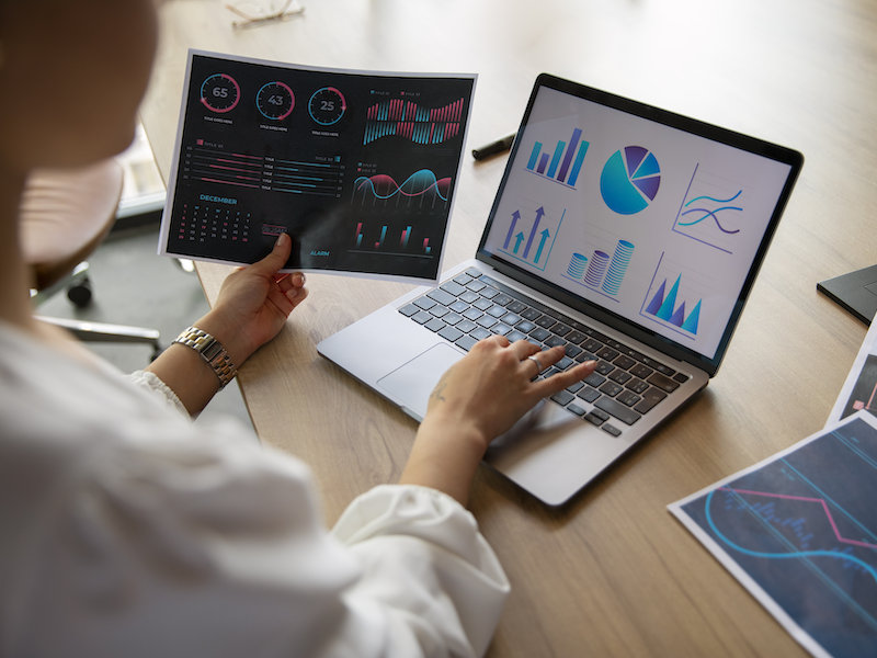 Researcher analyzing data charts on a screen