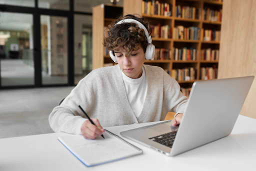 Student writing an essay on a laptop